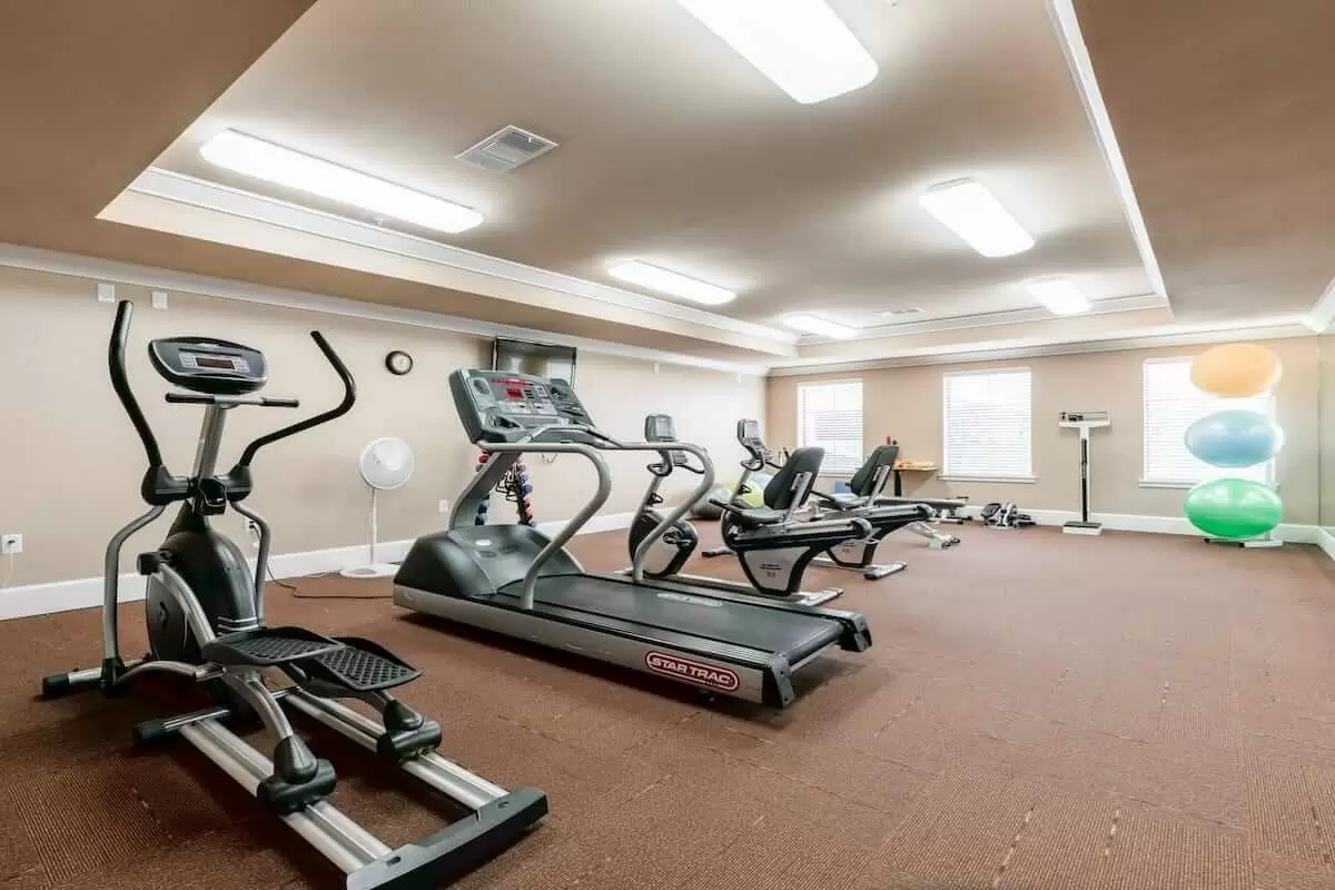 A well-equipped gym with treadmills and elliptical machines for fitness enthusiasts.