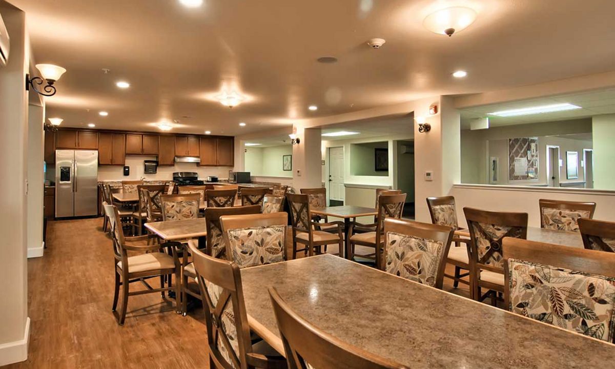 Cozy dining area with neatly arranged tables and chairs.