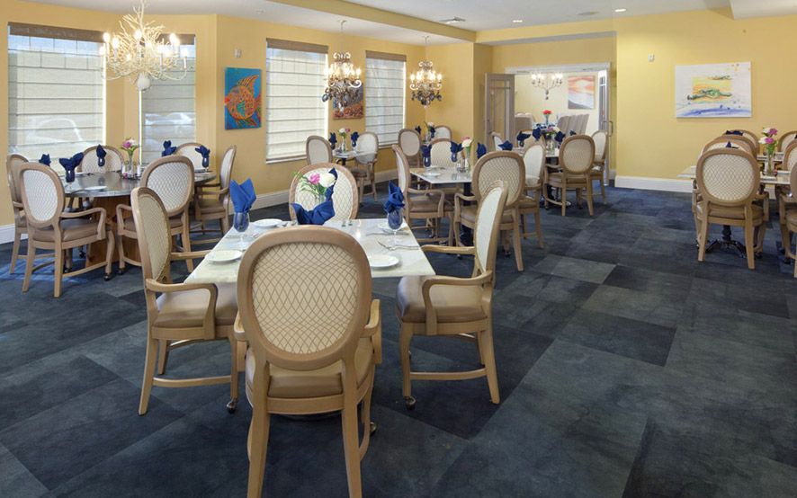 A well-decorated dining area with elegant table settings and chandeliers.