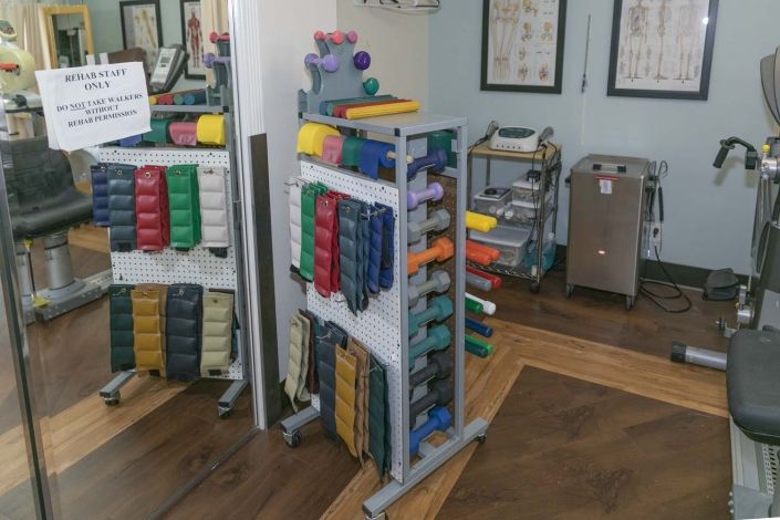 A collection of exercise bands neatly organized in a physical therapy or fitness room.