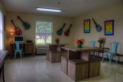 A vibrant and inviting classroom decorated with guitars and flowers, showcasing a creative learning environment.