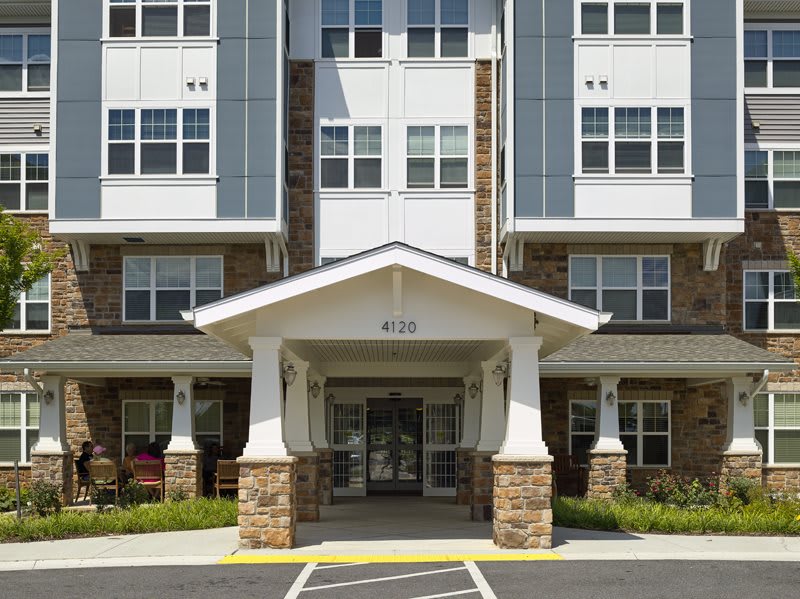 Entrance to a modern apartment building with stone accents.
