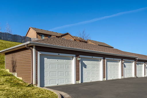 A modern home with a three-car garage and a neatly paved driveway.