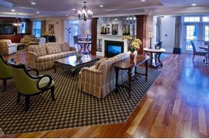 Elegant living room with cozy sofas, a central fireplace, and stylish decor.
