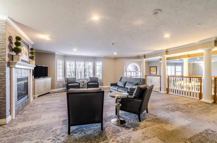 A spacious living room with modern furniture and large windows.