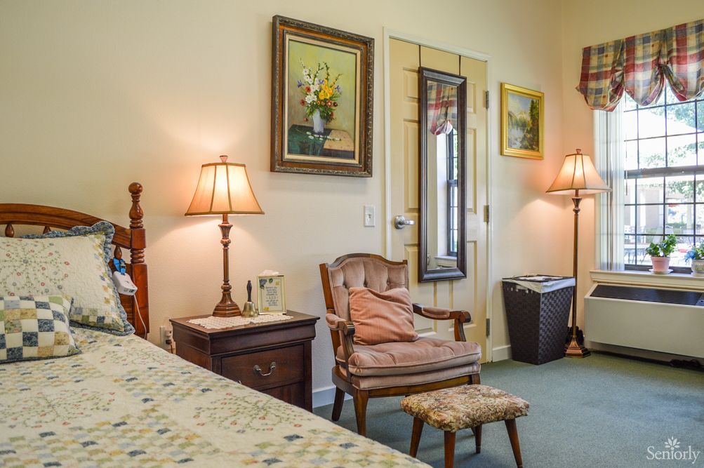 A cozy bedroom with classic furniture and warm lighting.