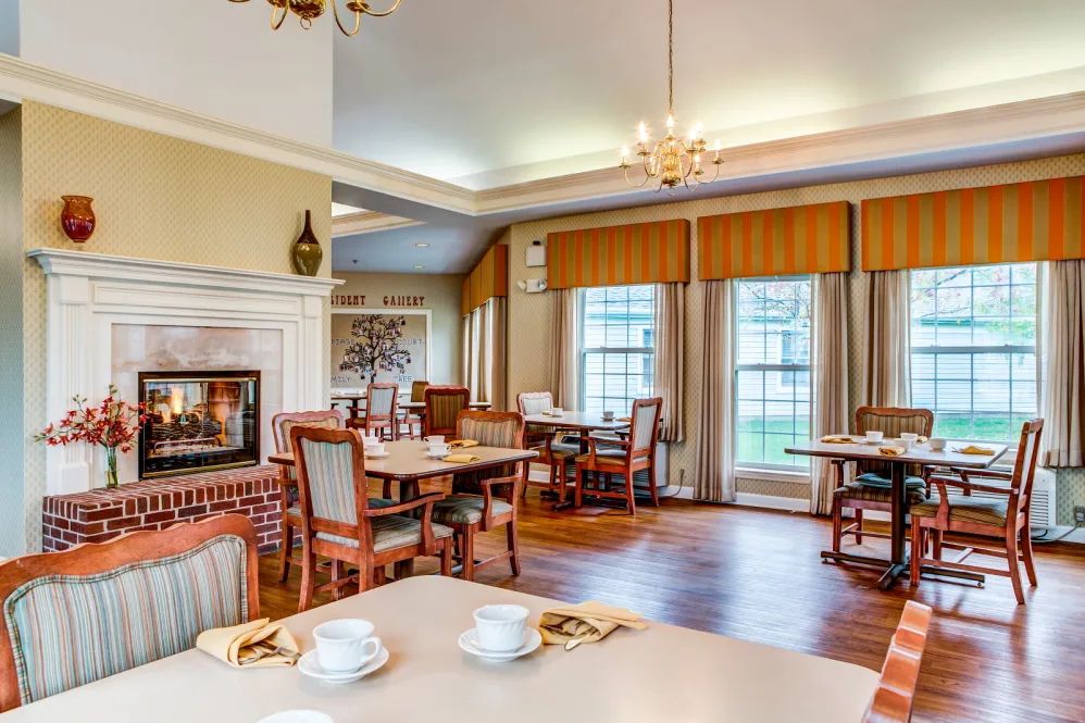 A cozy dining room with elegant furnishings and large windows.