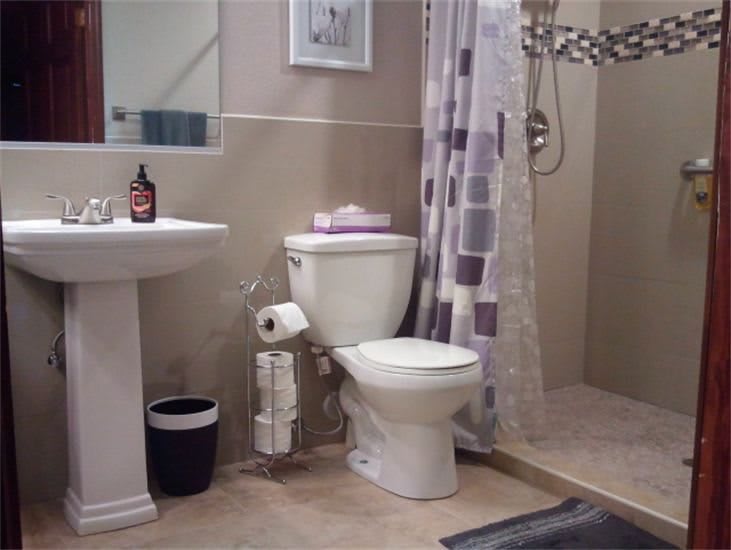 A well-organized bathroom with a toilet, sink, and shower.