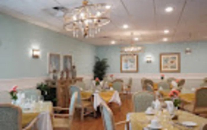 An elegant dining room with chandeliers and neatly arranged tables.
