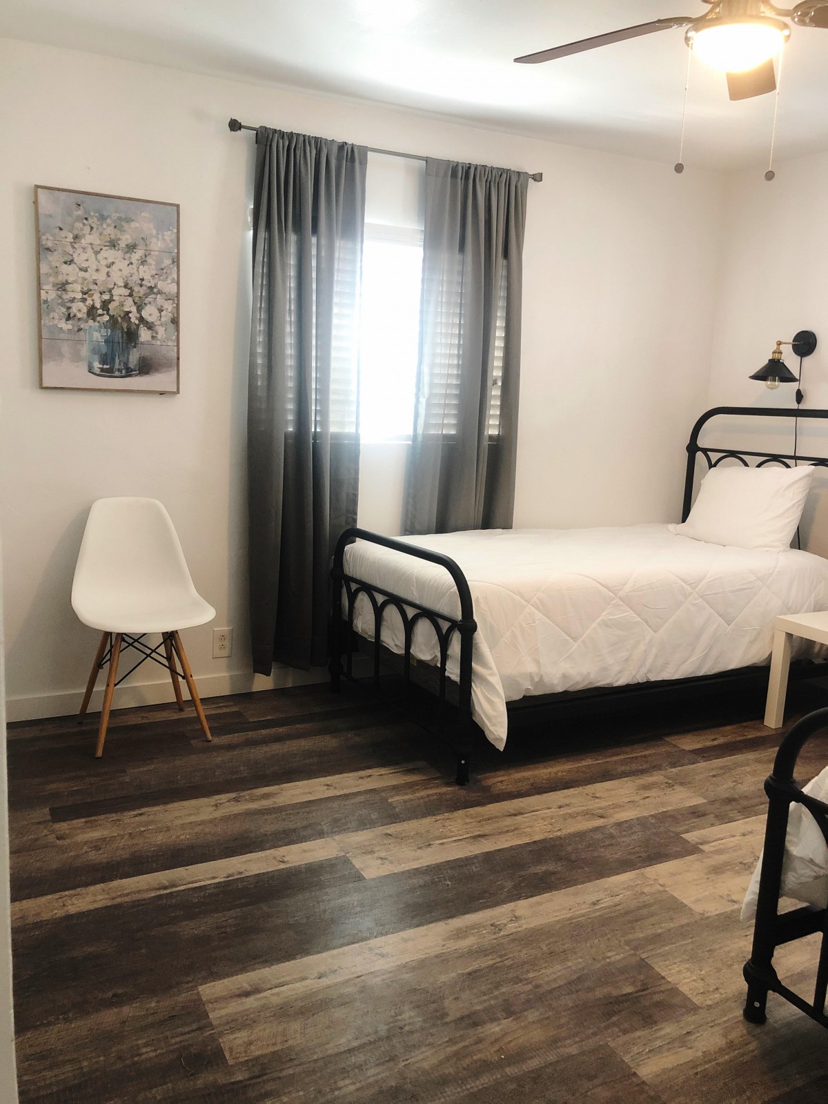 A minimalist bedroom with a single bed and modern decor.