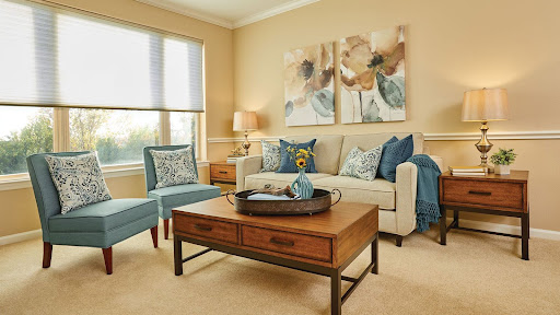 A cozy and elegantly designed living room featuring a stylish sofa, accent chairs, and tasteful artwork.