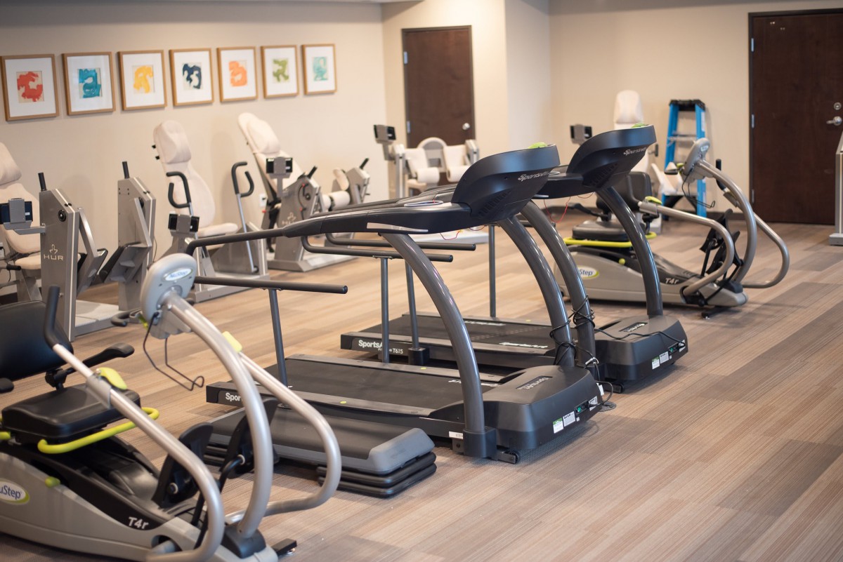 A clean and well-equipped gym with treadmills and exercise bikes.