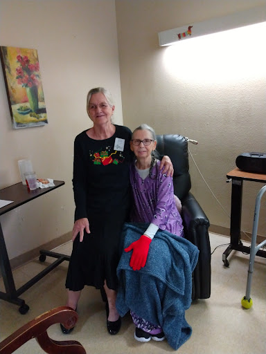 A caregiver shares a warm moment with a patient in a hospital setting.