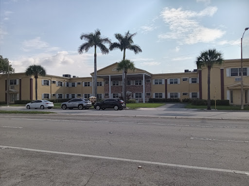 A pleasant view of a modern building surrounded by palm trees on a sunny day.