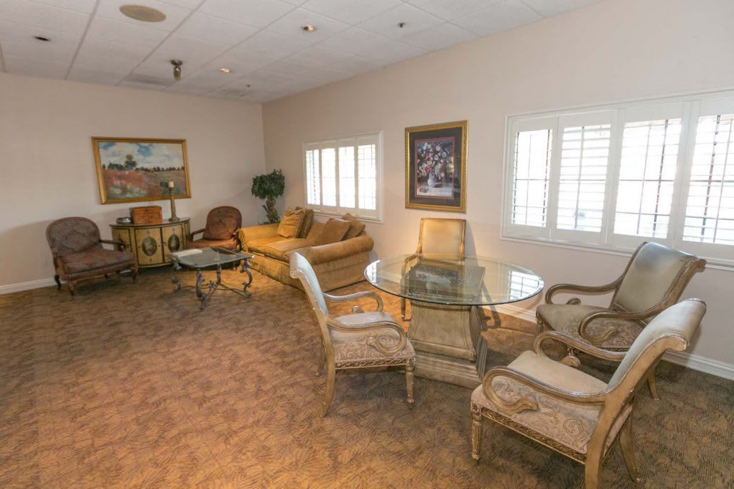A cozy living room with comfortable seating and decorative artwork.