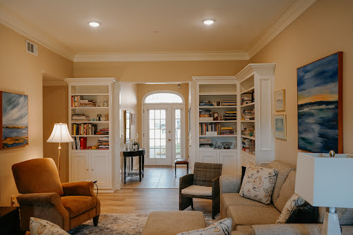 A warm and inviting living room with built-in bookshelves and comfortable seating.