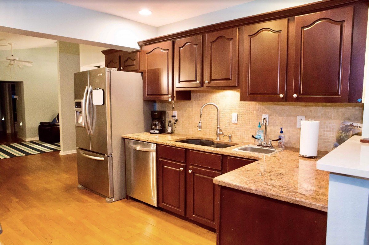 A modern kitchen with wooden cabinets and stainless steel appliances.