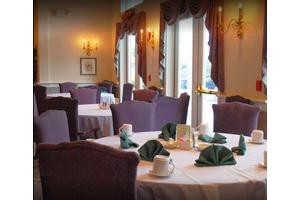 Elegant restaurant dining area with neatly set tables and cozy ambiance.
