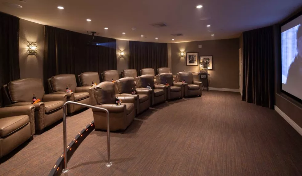 A cozy home theater with recliner chairs and soft lighting.