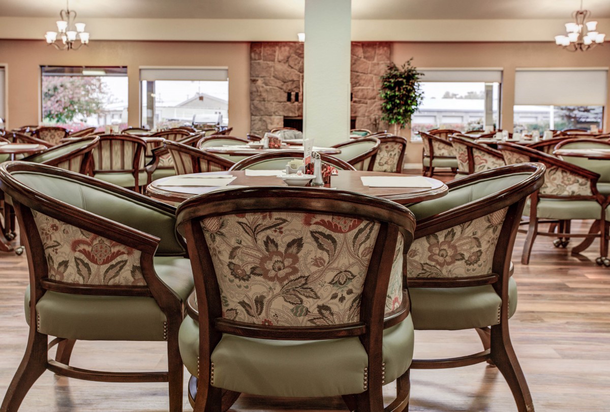 An elegantly furnished dining area with patterned chairs and neatly set tables.