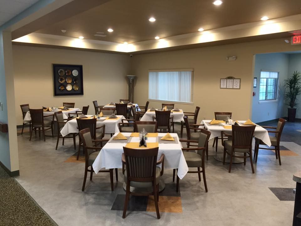 An empty restaurant dining area with neatly arranged tables and chairs.