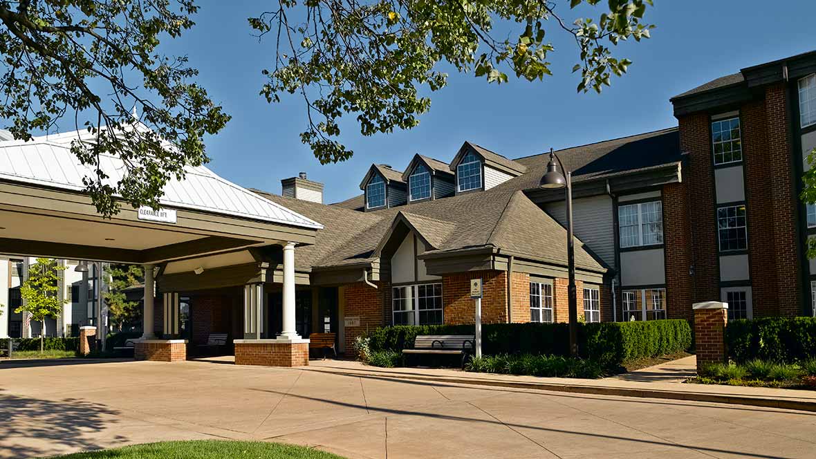 A modern residential building with a welcoming entrance and well-maintained landscaping.