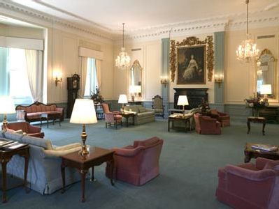 A spacious and elegant formal room with luxurious seating and classic decor.