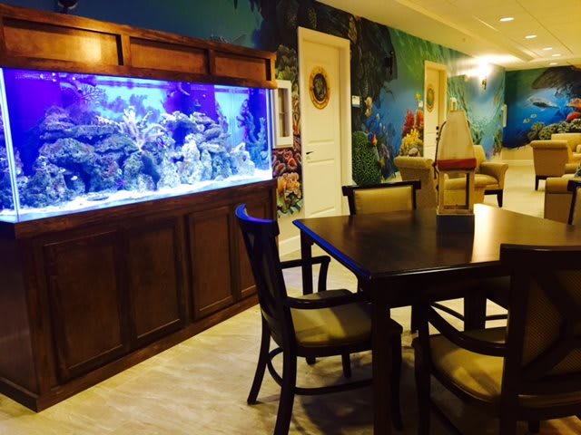 A beautifully decorated dining area featuring a large aquarium.