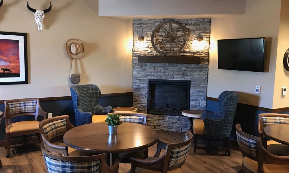 A cozy living room with a stone fireplace and comfortable seating arrangement.