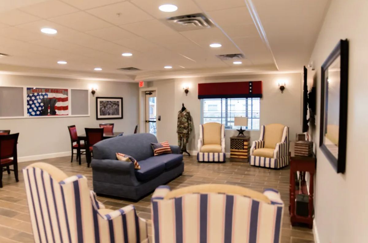 A cozy living room with striped upholstery and traditional furniture.