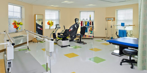 A well-equipped rehabilitation gym featuring various exercise machines and equipment.