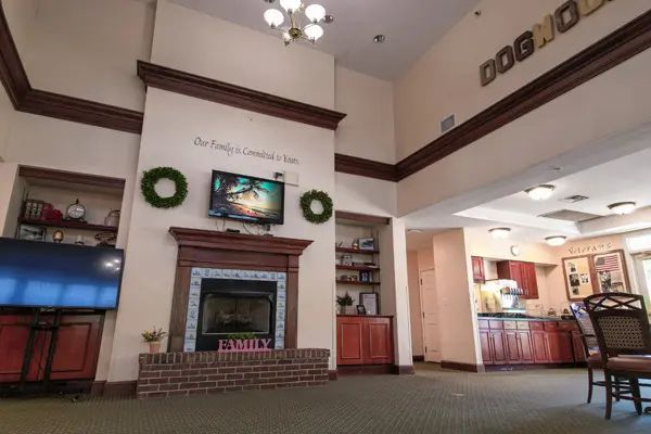 A spacious lobby with a fireplace, television, and festive decorations.