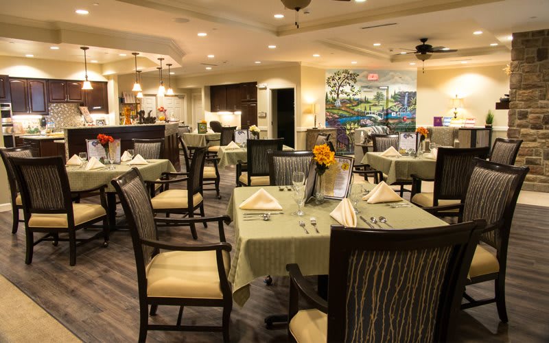 An elegantly decorated restaurant dining area with neatly arranged tables and chairs.