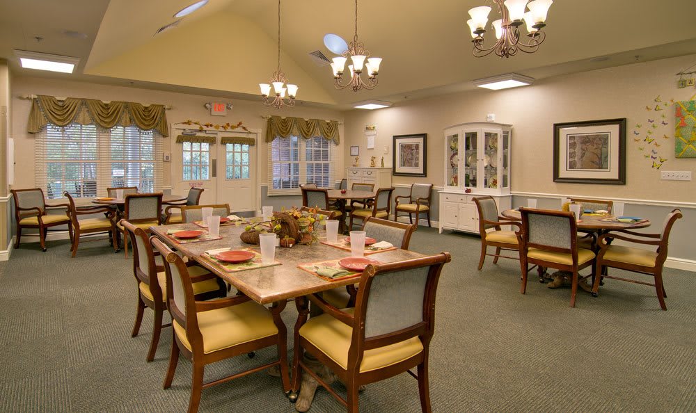 A well-decorated dining room with elegant lighting and furniture.