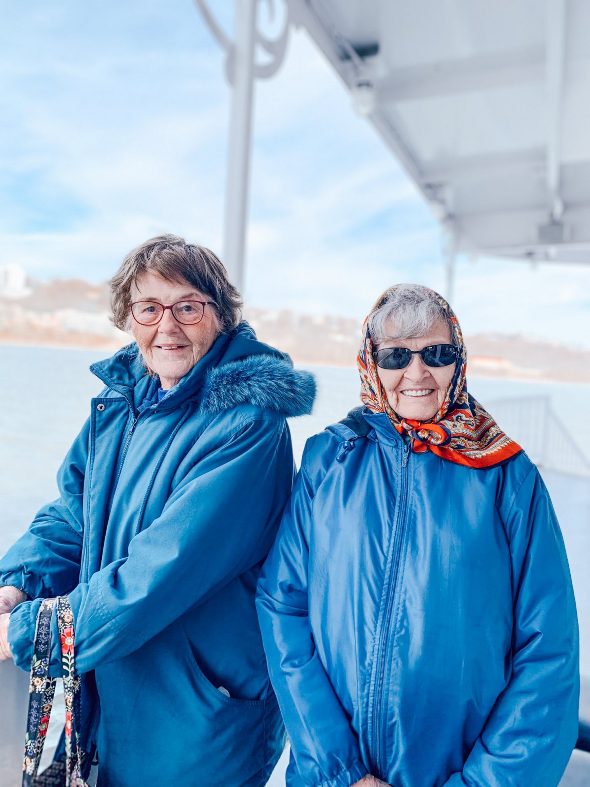 Two friends enjoying a day outdoors in warm winter clothing.
