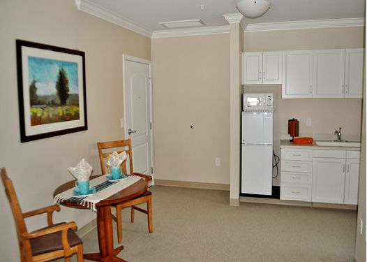 A cozy apartment interior with a small kitchen and dining area.