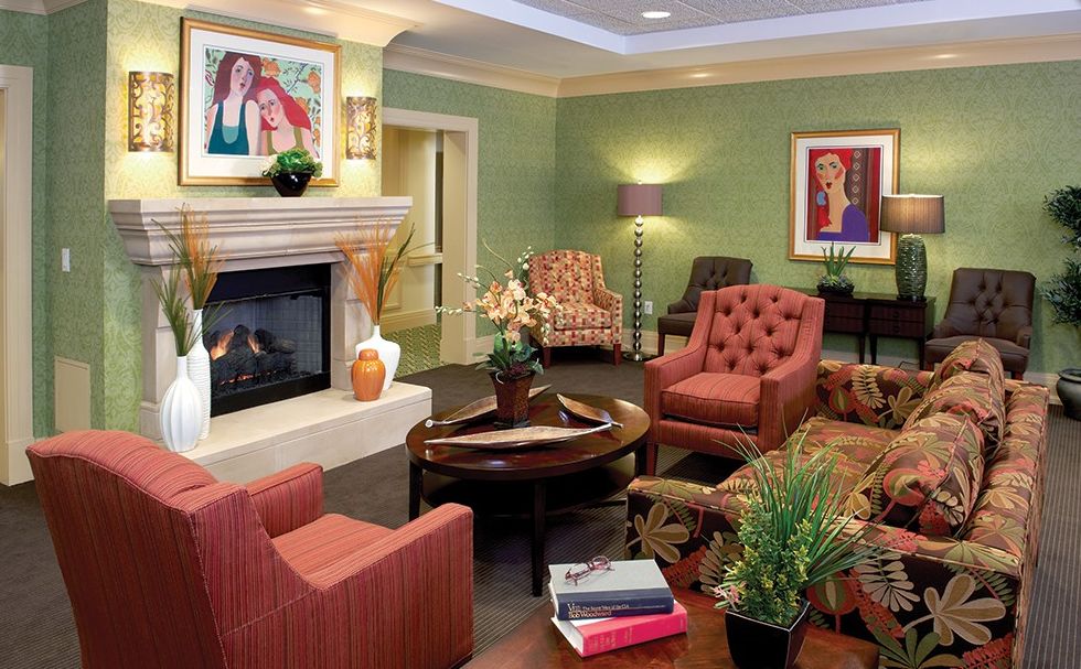 A cozy living room featuring a modern fireplace, comfortable armchairs, and stylish decor.