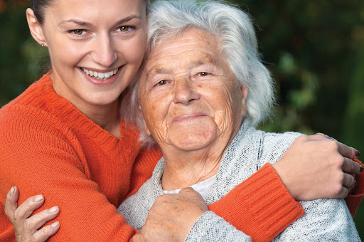 A joyful moment shared between a young woman and her grandmother, showcasing love and connection.
