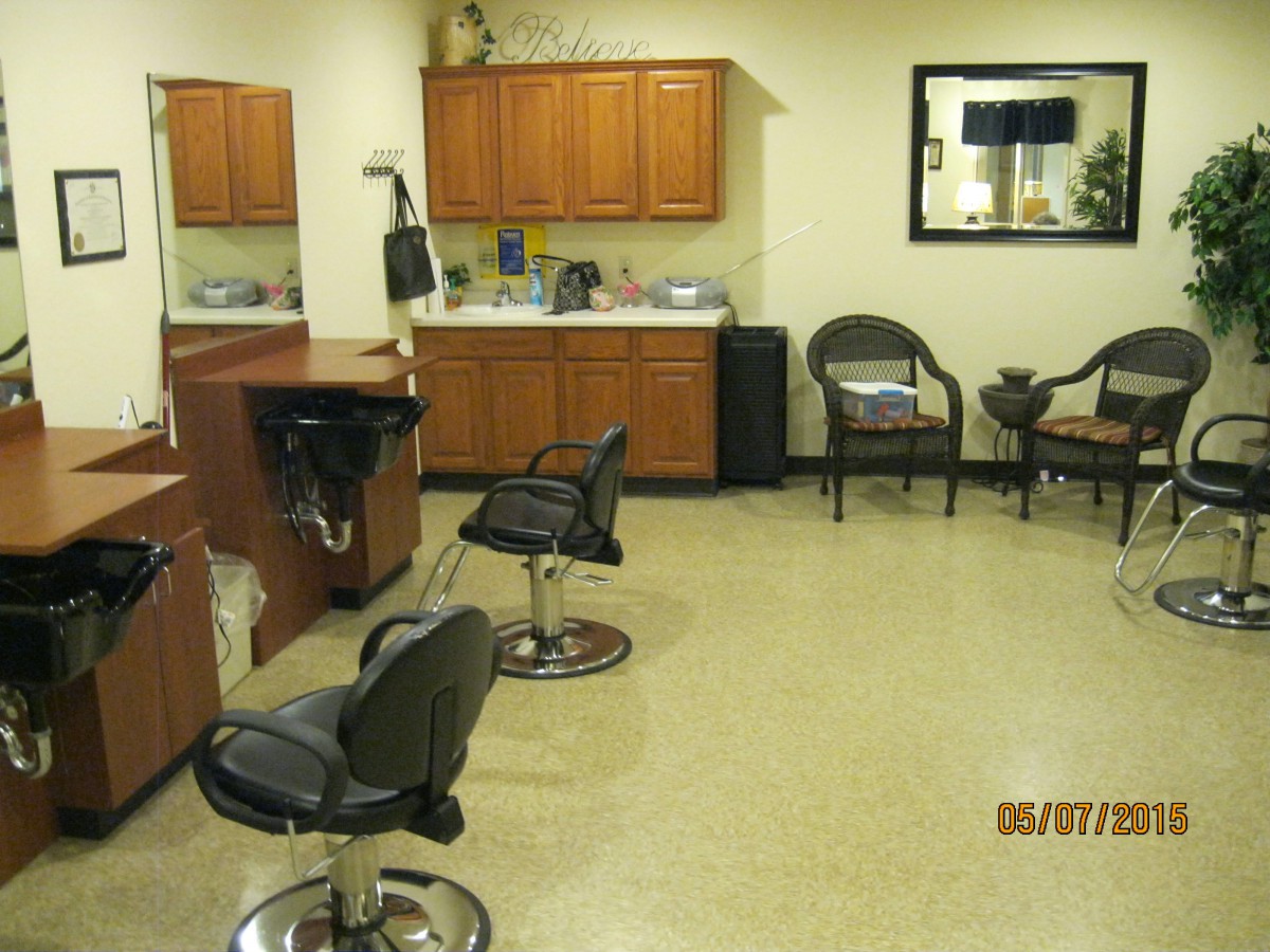 Interior of a hair salon with styling chairs and a waiting area.