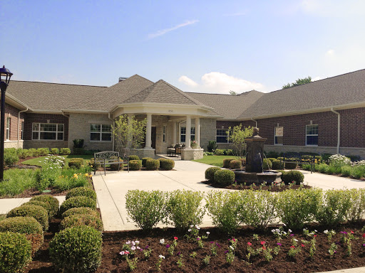 A beautiful residential house with a well-maintained garden and a welcoming front porch.