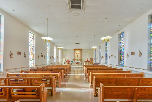 Interior view of a serene church, highlighting the wooden pews and peaceful ambiance.
