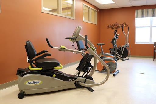 A modern gym space featuring various exercise machines for a complete workout.