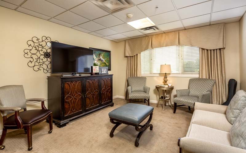 A cozy waiting room with comfortable seating and a TV.