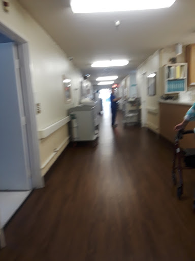 A busy hospital corridor with healthcare professionals attending to patients.