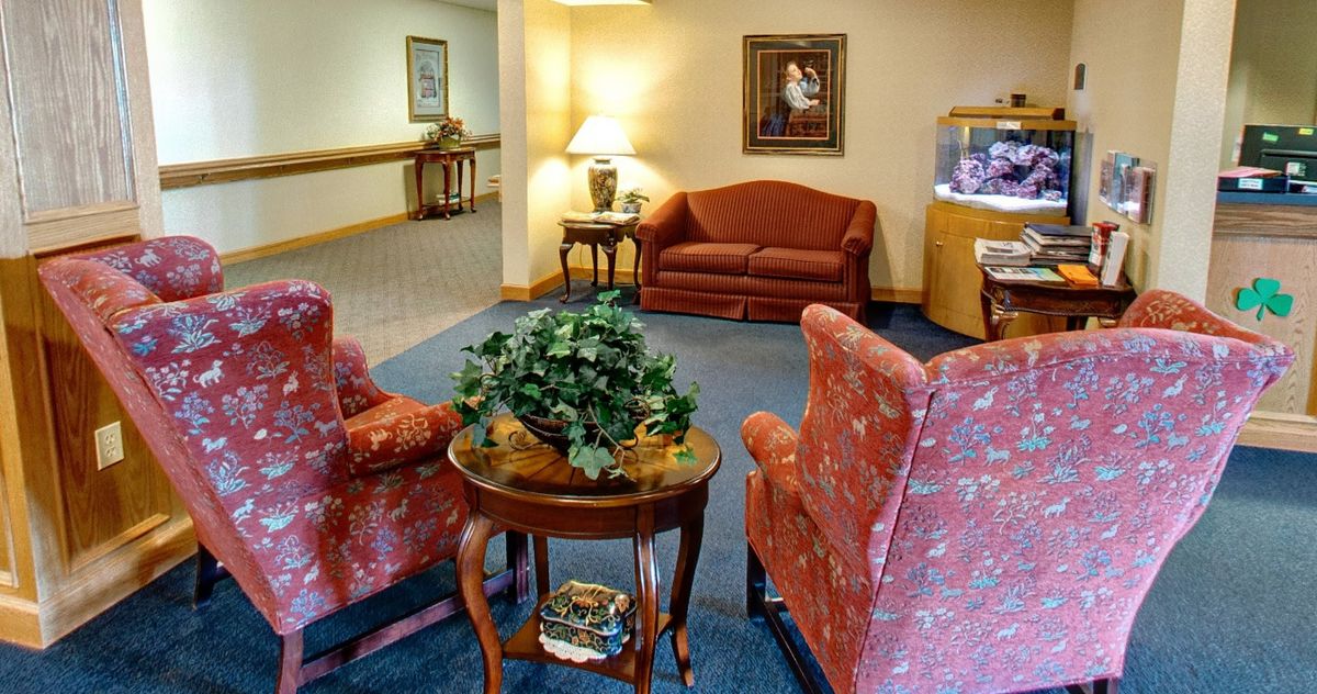A cozy lobby area with sofas, armchairs, a coffee table, and decorative elements.