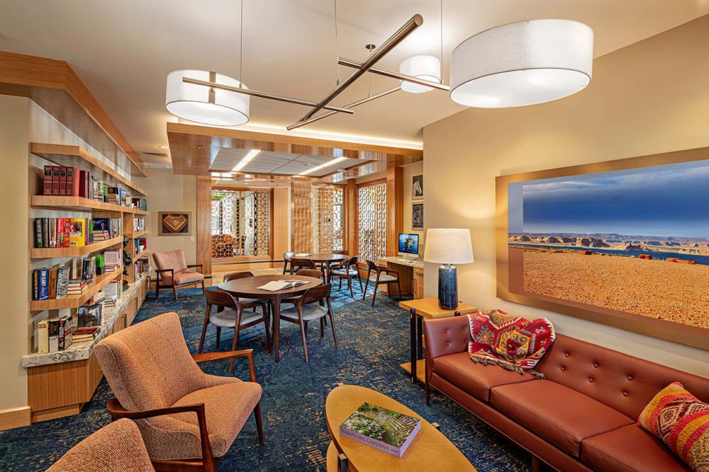 A modern library interior with comfortable seating and warm lighting.