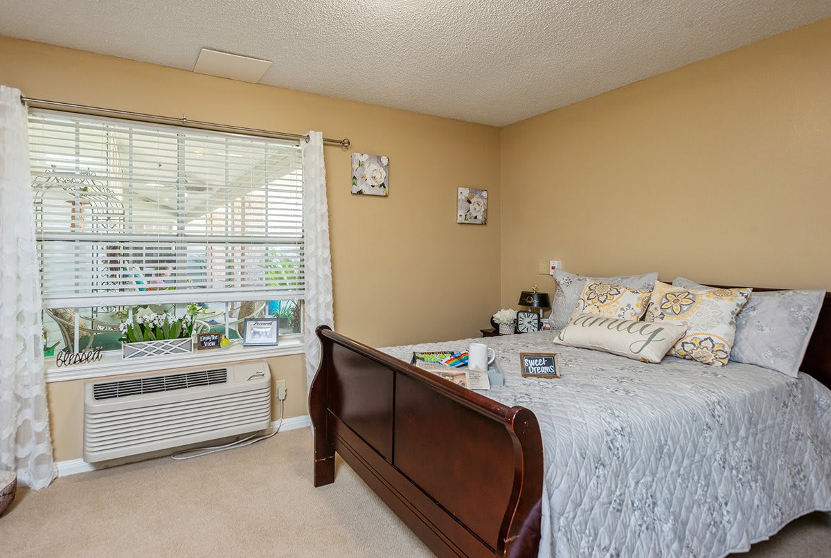 A cozy bedroom with a large bed and window, featuring elegant decor.