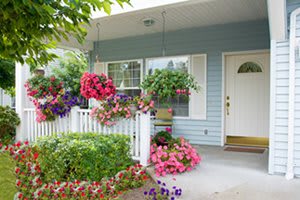 A charming front porch adorned with vibrant flowers and hanging baskets.