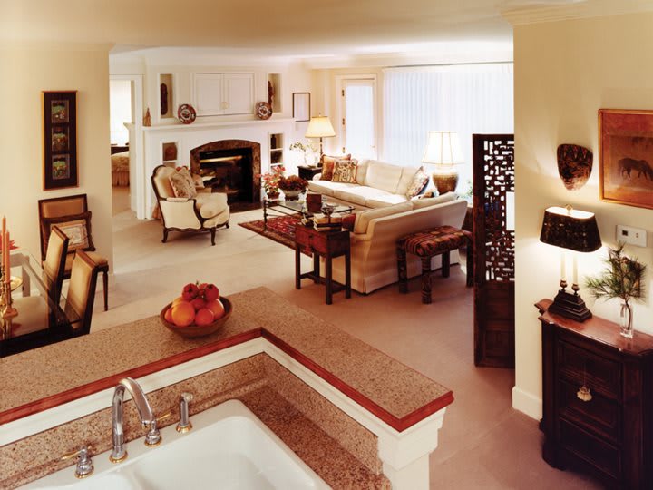 A spacious and elegantly designed living room with a cozy fireplace and comfortable seating.