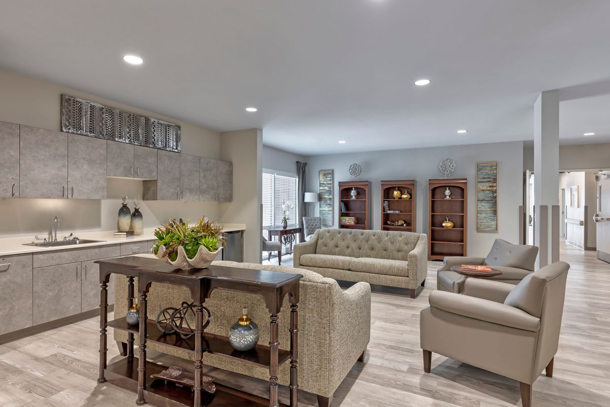 A cozy open-concept living room with stylish furniture and warm lighting.